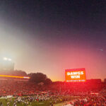 Sanford Stadium at dusk with Dawgs Win on jumbotron.