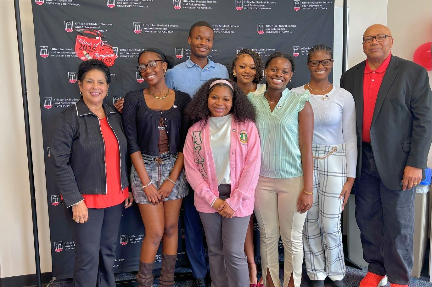 Achieve Atlanta Scholars and partner pose in front of a photo backdrop for the 2025 Achieve Atlanta Sendoff Day