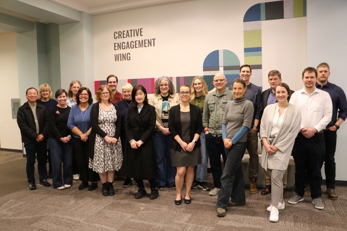 Group photo of UGA faculty and staff posting outside the Creative Engagement Wing