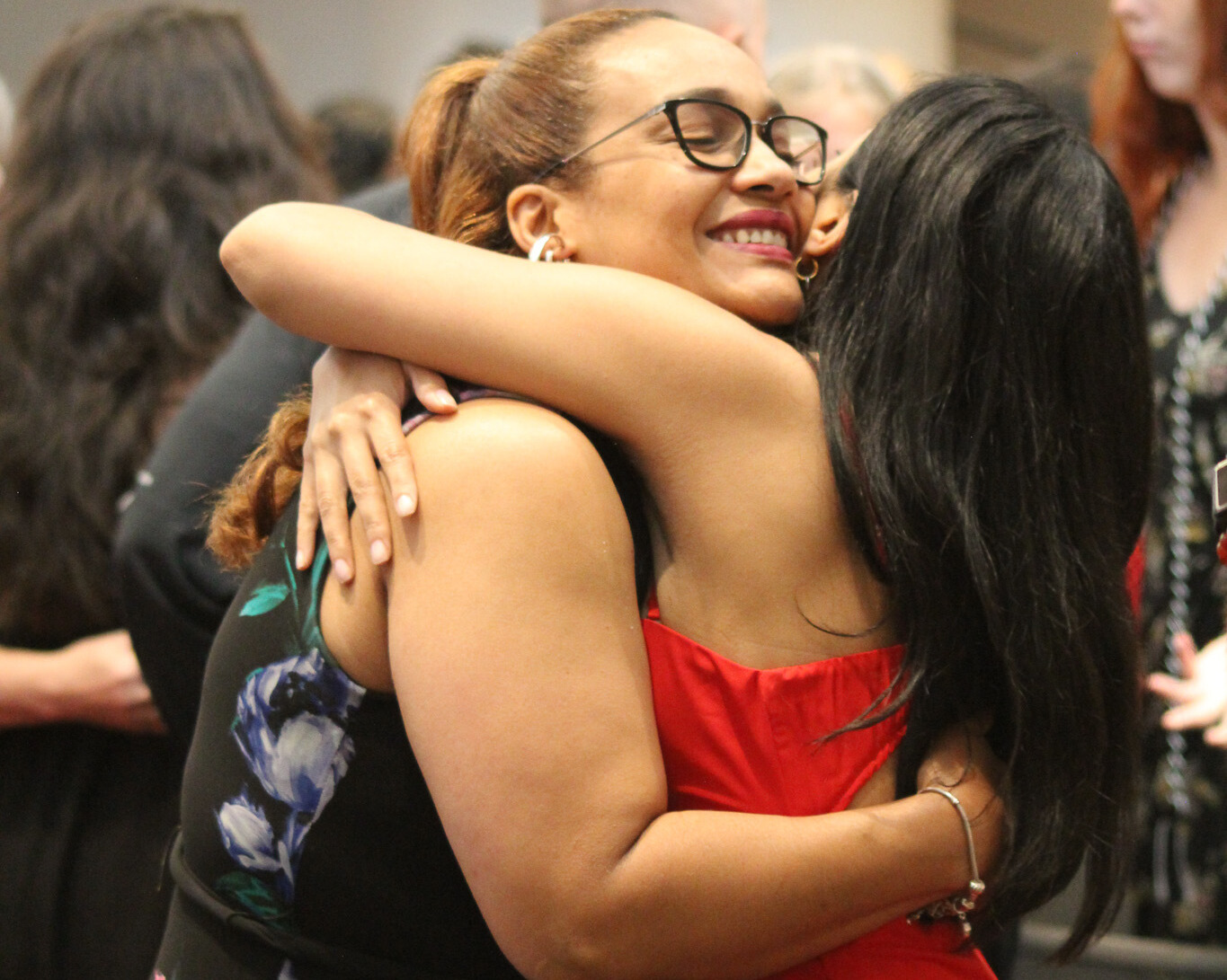 Two students embrace at First-Gen graduation celebration