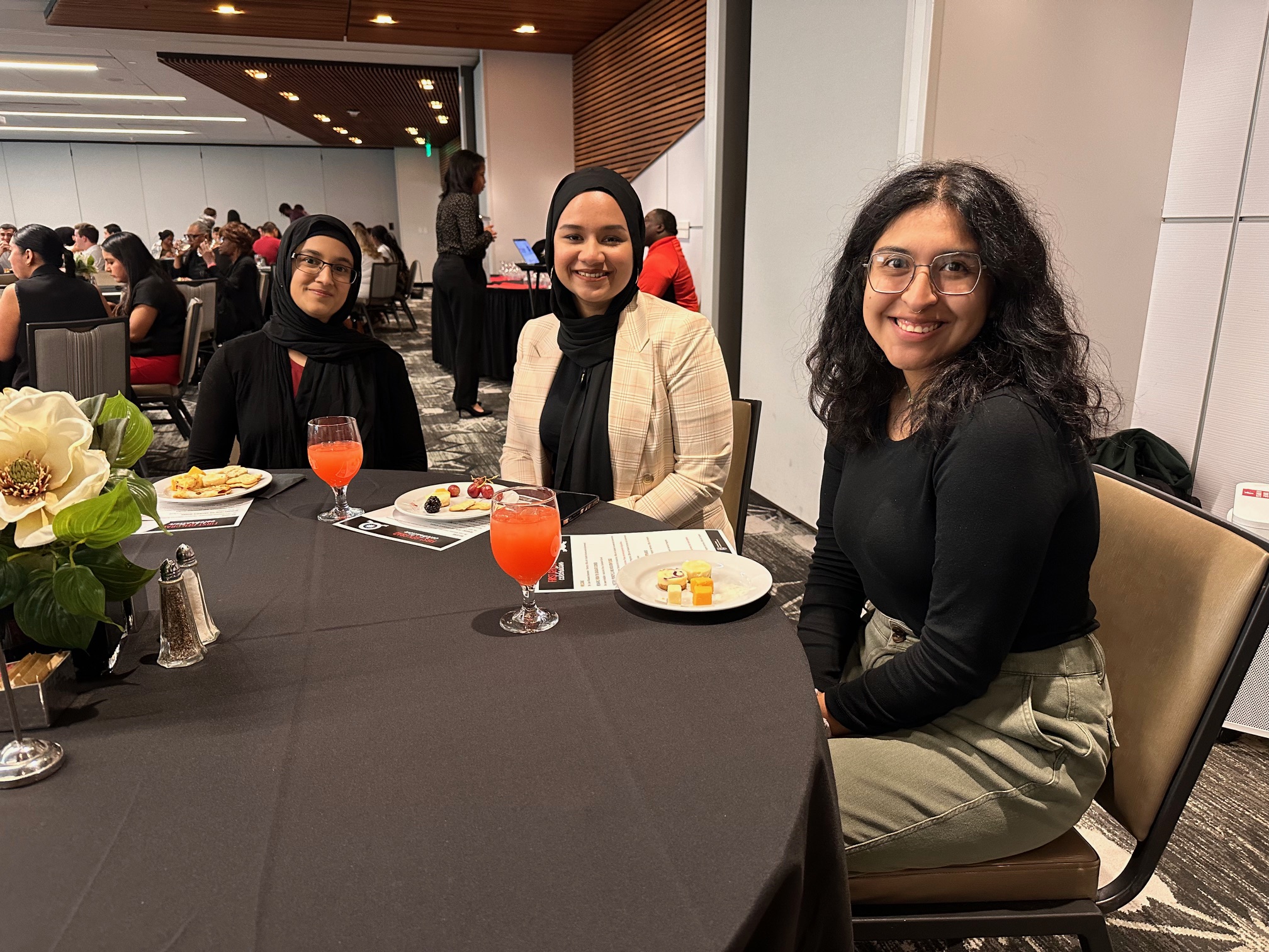 First-generation students sitting at table at first-gen celebration.