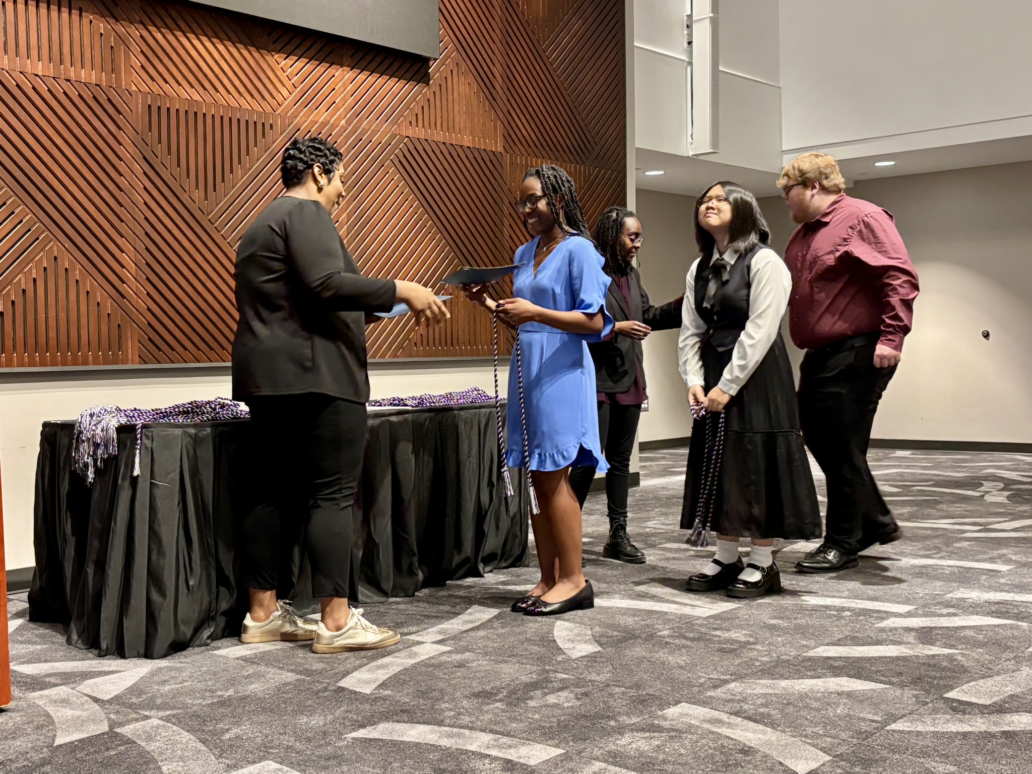 Members being inducted into the Tri-Alpha honor society