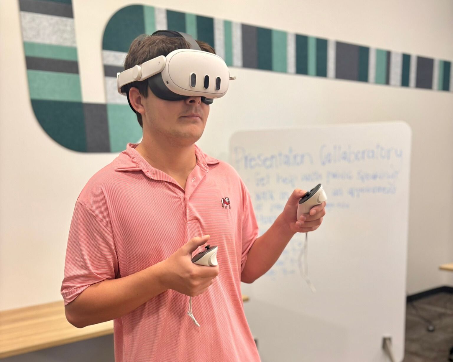 A UGA student wears virtual reality headset while practicing a presentation in the Presentation Collaboratory