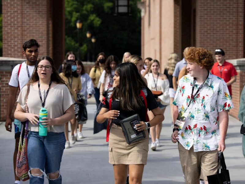 From left, incoming freshman Maris Wright talks with orientation leader Vidhi Patel and fellow freshman Carson Whiee as they walk together to their small group time at new student orientation in the Tate Student Center. (Photo by Andrew Davis Tucker/UGA)