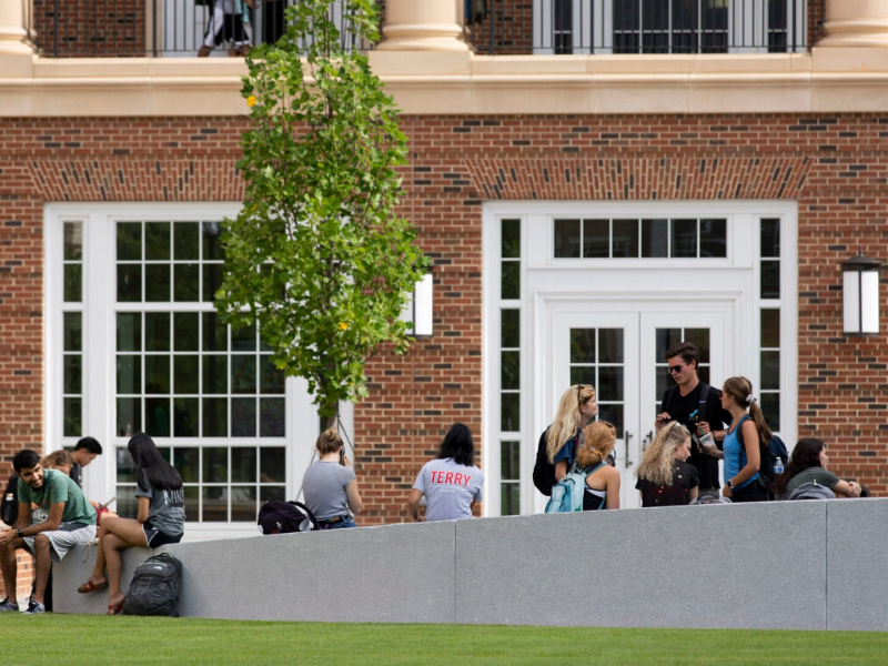 UGA students talking outside of a university building