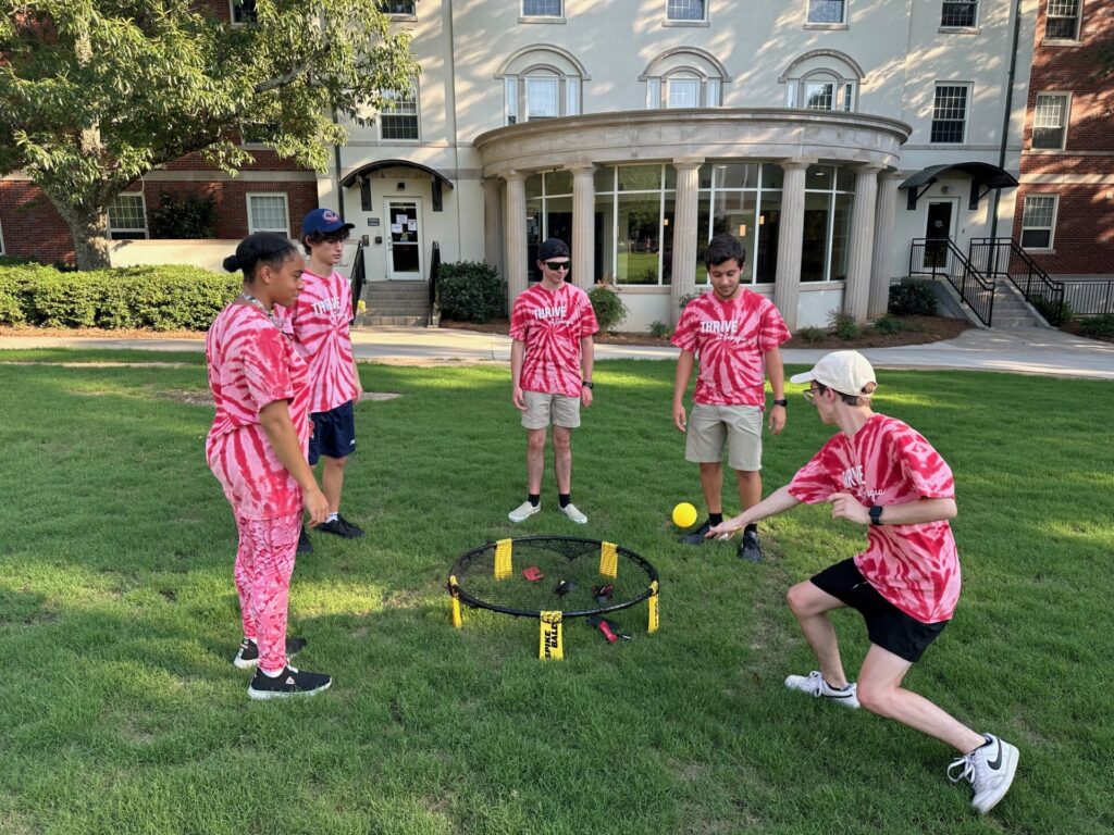 Five students play a yard game as part of the Thrive at Georgia program